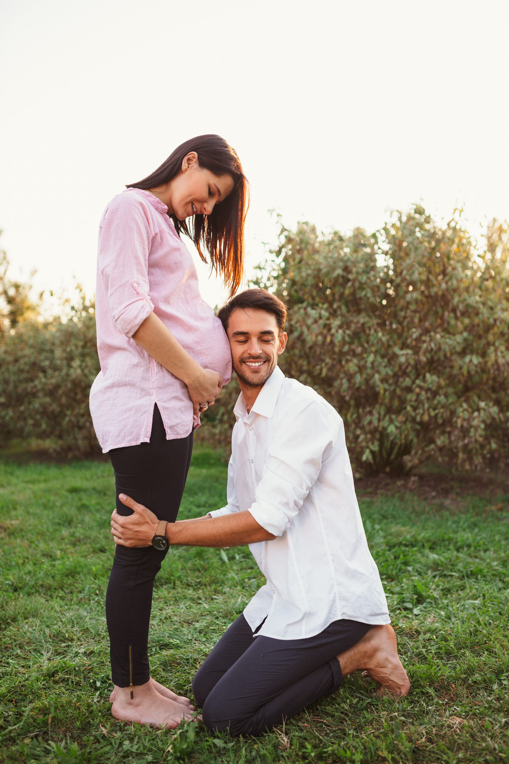 happy and young pregnant couple